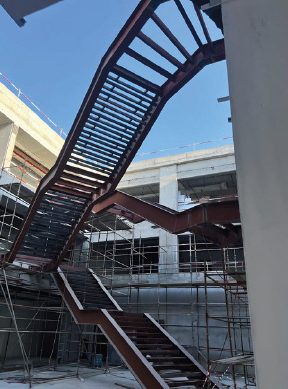 Steel staircase during installation with scaffolding