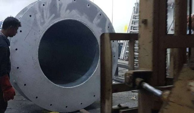 Close view of a steel pole base plate and bolt holes